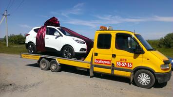 эвакуатор везет машину-подарок